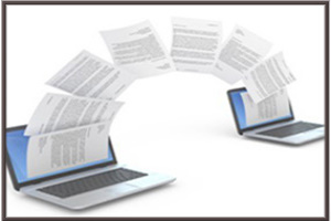 Sheets of information transferring from one laptop to another.