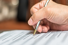 Hand writing with a pen.