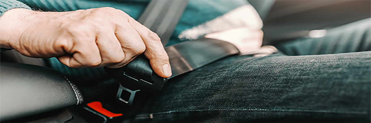 Photo of person hooking a seatbelt.